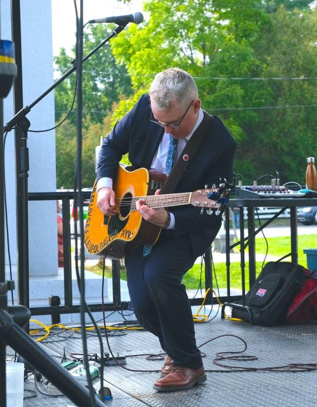 David Porteous performing outdoors on acoustic guitar