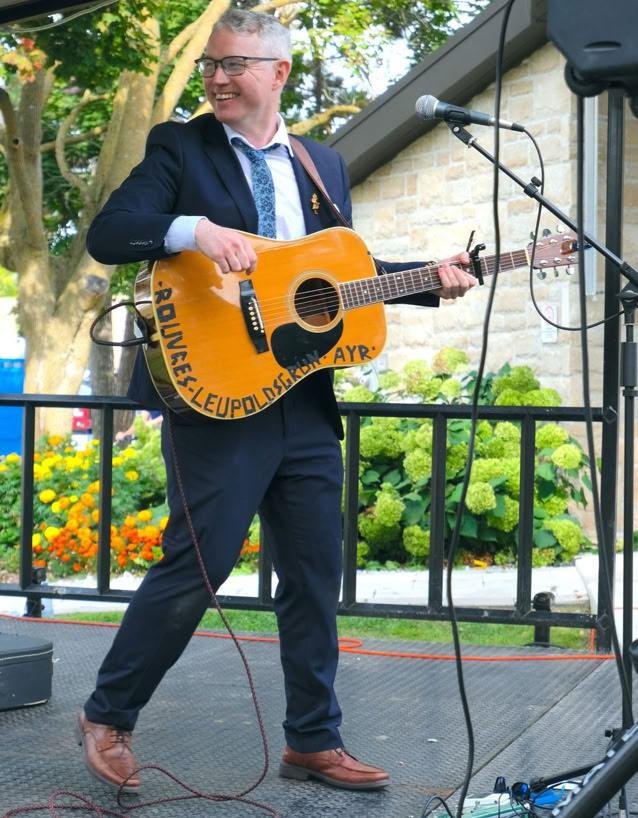 David Porteous with acoustic guitar outdoors