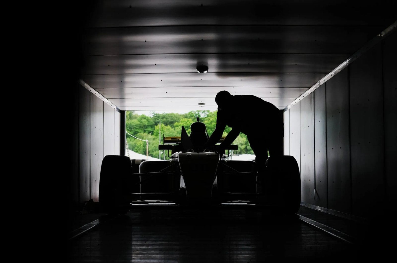 Race car silhouetted in a garage